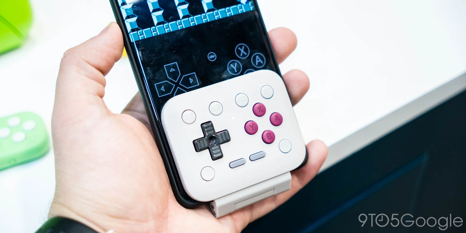 8BitDo FlipPad compact USB-C mobile game controller connected to a smartphone