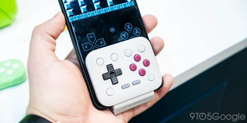 8BitDo FlipPad compact USB-C mobile game controller connected to a smartphone