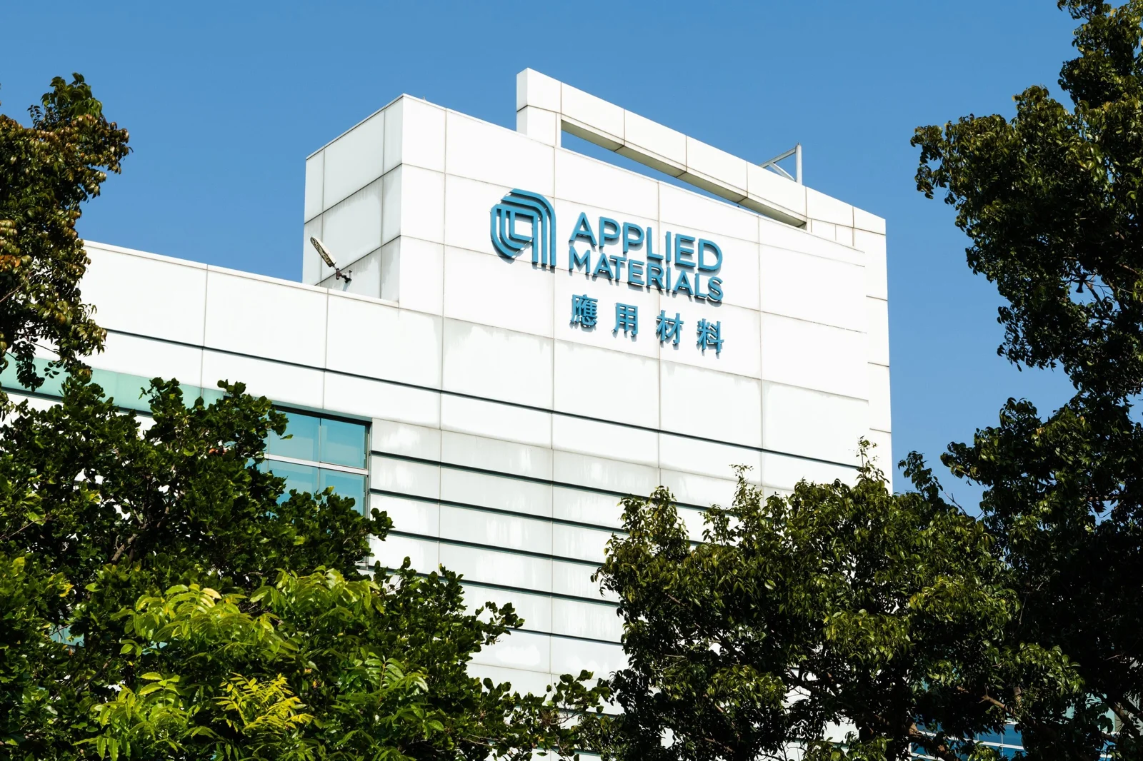 Applied Materials corporate logo displayed at company facility background