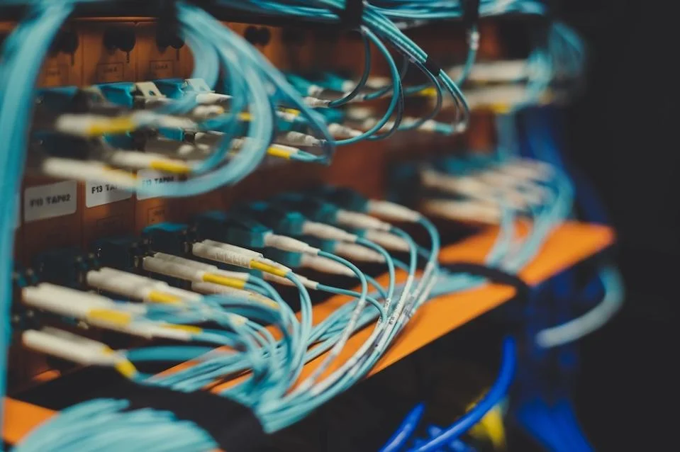 Network cables in a server rack representing interconnected AI agent protocols