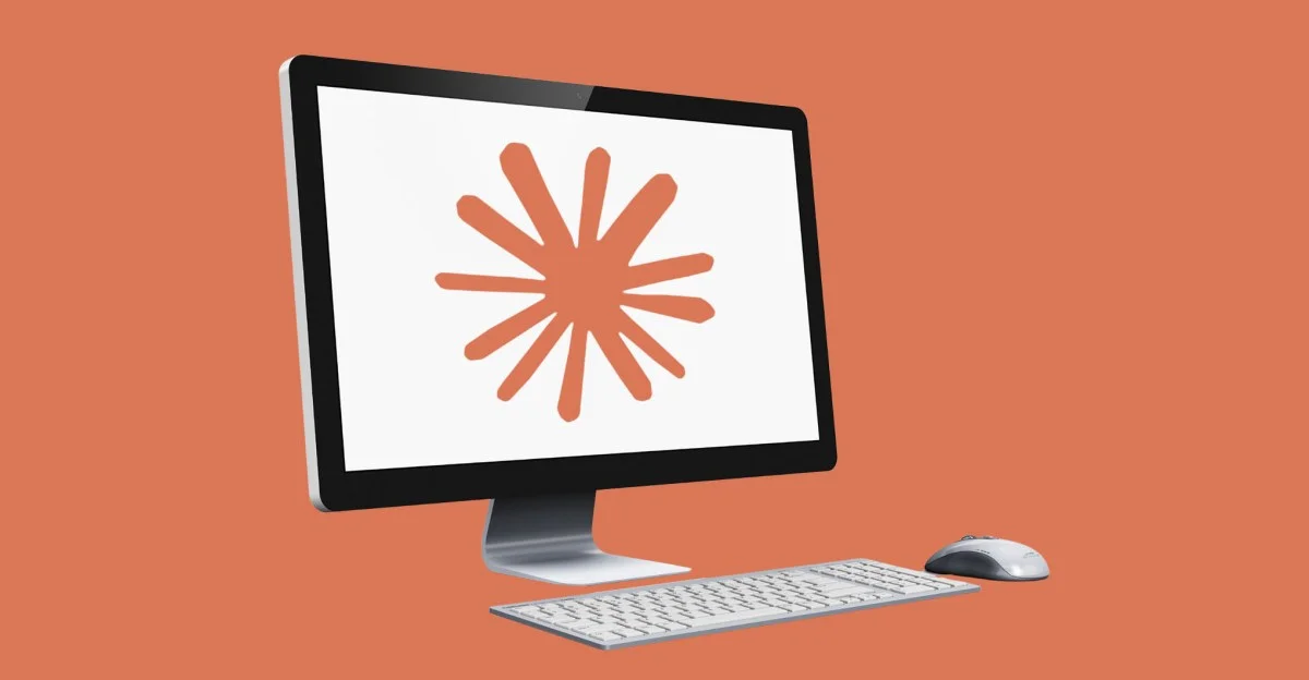 The Claude logo displayed on a computer screen against a vibrant orange background.