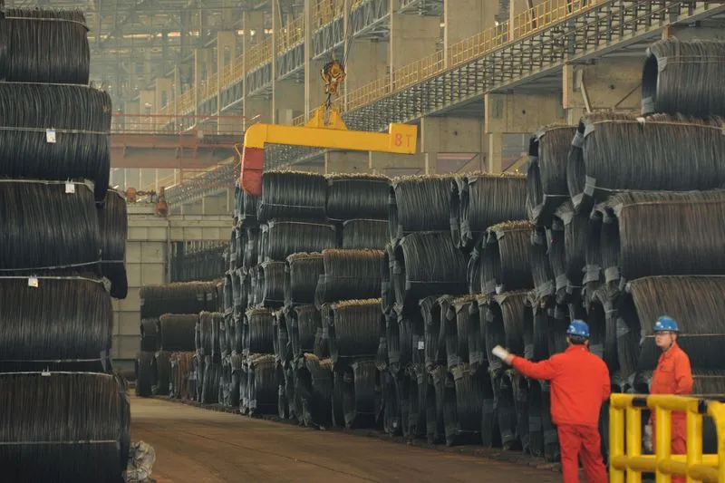 Containers stacked at a busy industrial shipping port in China amid inflation data release.