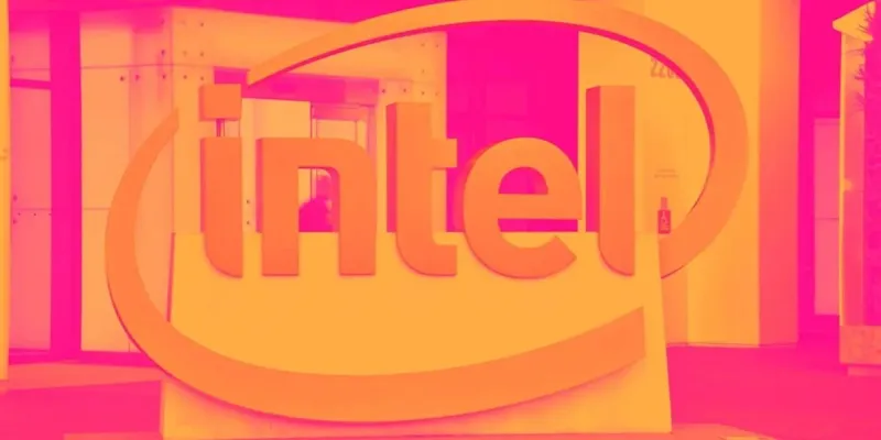 Великий тривимірний логотип компанії Intel у яскравих помаранчевих та рожевих кольорах на фоні сучасного офісного приміщення.