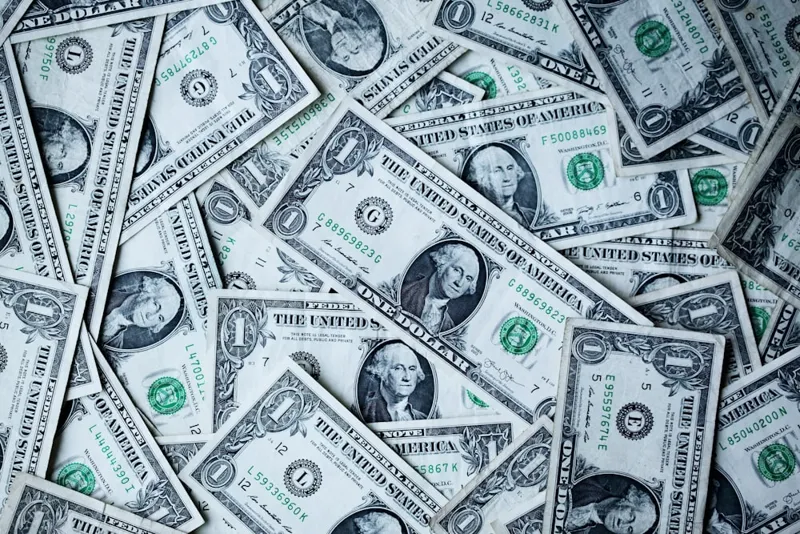 A stack of currency and financial growth indicators representing central bank monetary policy