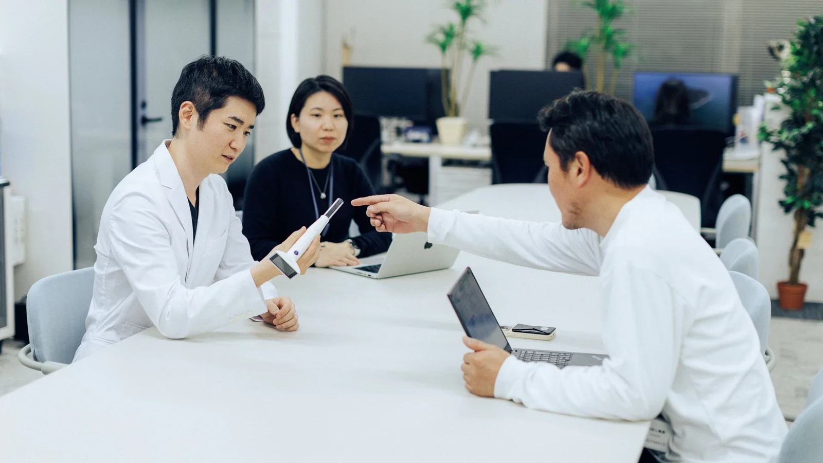 A medical professional examining a patient's throat using the Nodoca AI optical device.